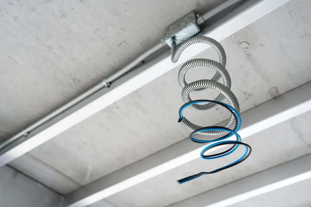 Flexible conduit hanging from ceiling