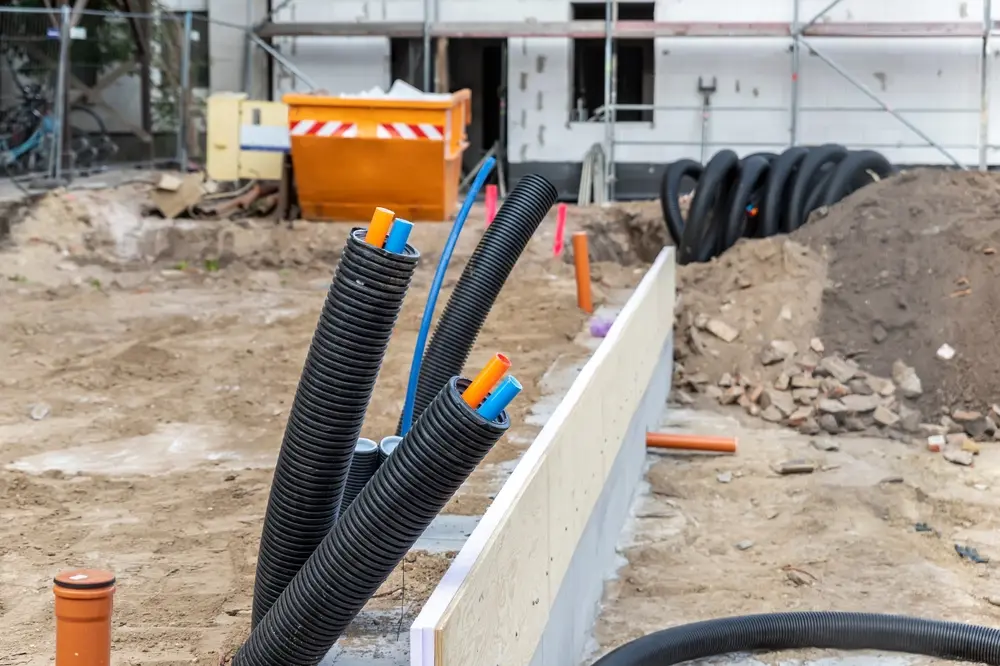 Flexible conduit protecting wires on construction site